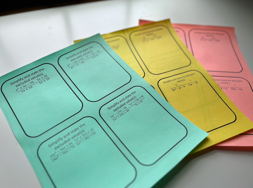 Image of differentiated task cards on red, yellow, and green paper.